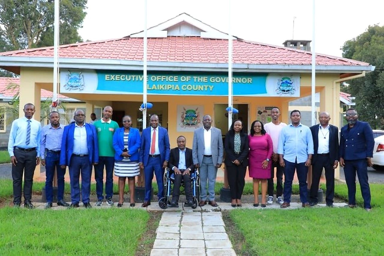 A large group photograph outside the Executive Office of the Governor, Laikipia County.